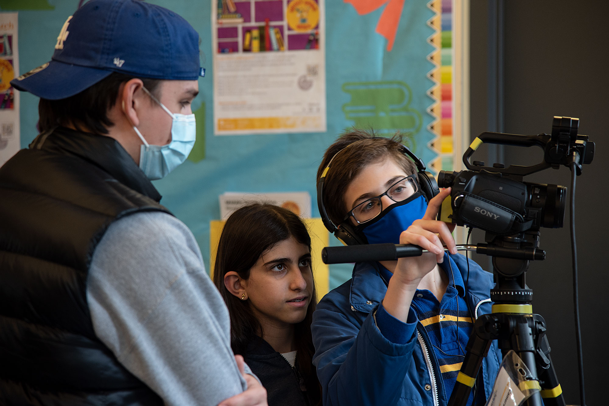 Teens working on a film in the library