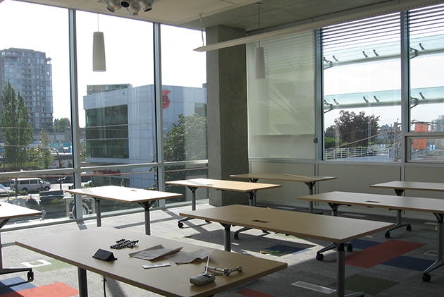 The east side of the 3rd floor program room, set up with tables.