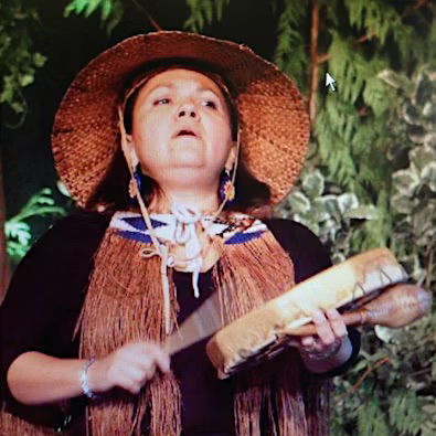 Tsitsáyxemaat Rebecca Duncan playing a drum