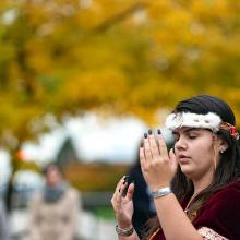 Indigenous woman doing dance for canoe ceremony