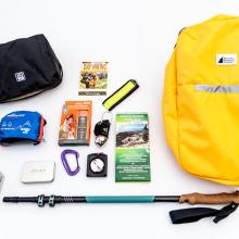 A hiking backpack with its contents on display