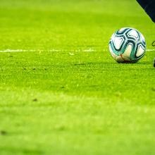 closeup of the boots of a soccer player dribbling a ball
