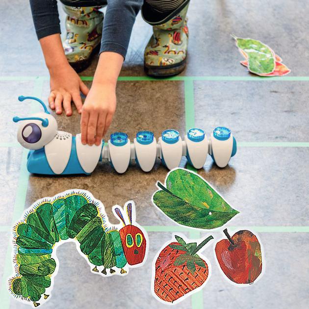Very hungry code-a-pillar Child playing with caterpillar technology device, with Eric Carle's very hungry caterpillar illustrations