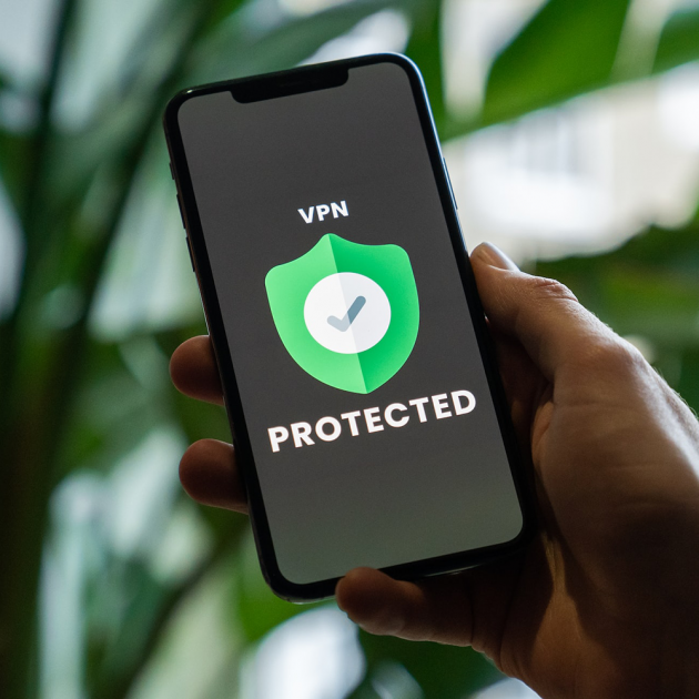 Person holding a smartphone with a VPN installed. Person holding a smartphone with a VPN installed.
