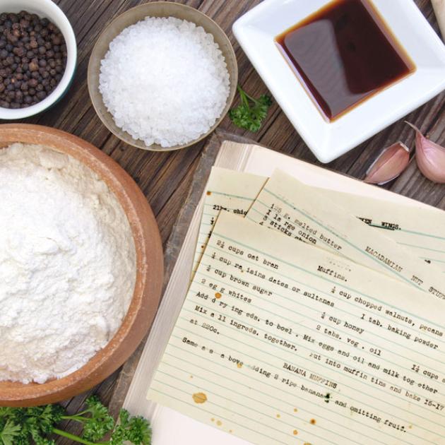 Community cookbook A photo of a bowl of flour, salt and peppercorns next to recipe index cards