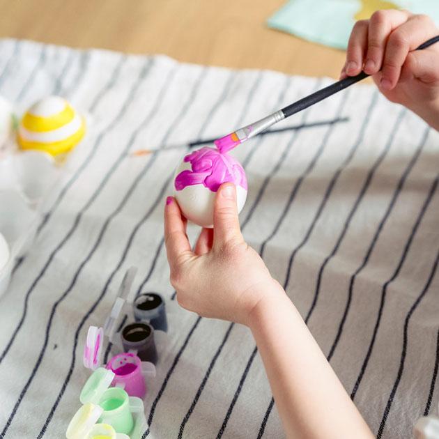 Nowruz egg painting Picture of a person painting an egg with pink paint