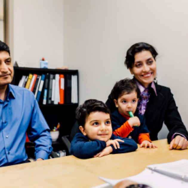 Information Session on New IRCC Special Measures for Iranians Family of 4 sitting behind a table