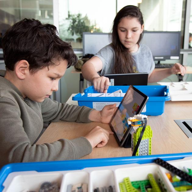 Boy and girl using tablet computers Boy and girl using tablet computers