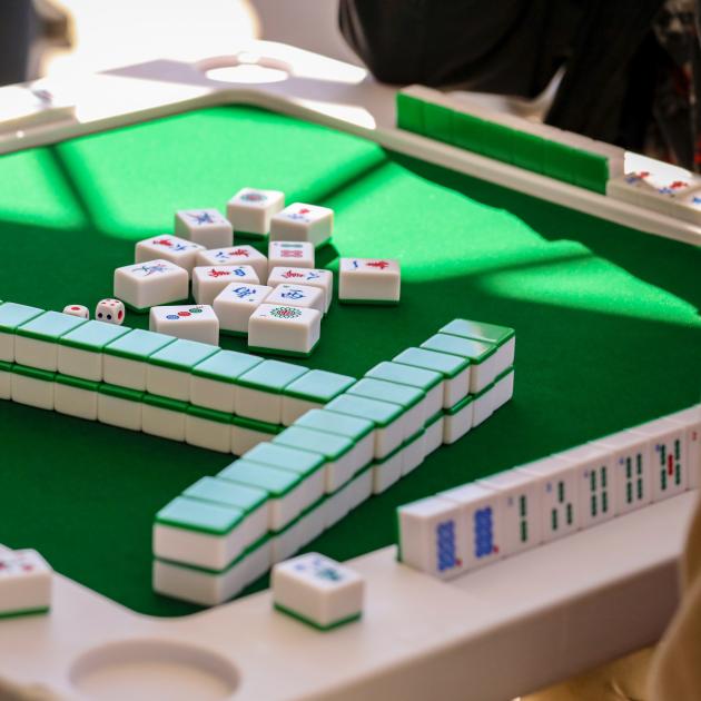 Mahjong tiles on a green table