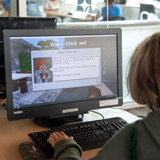 A child playing Minecraft on a computer