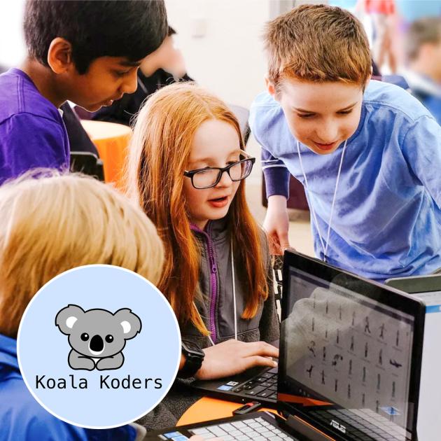 Koala Koders camp Children looking at computer screens, wearing blue and purple t-shirts