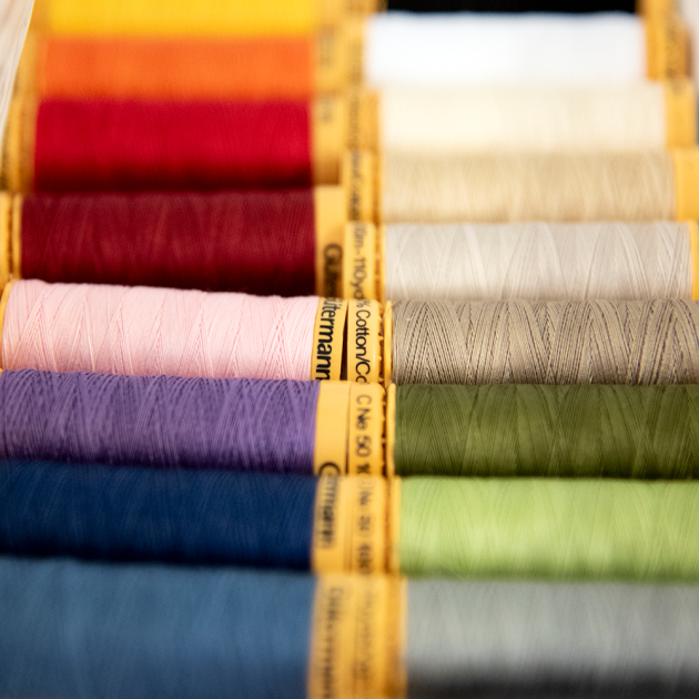 spools of colourful sewing thread spools of colourful sewing thread