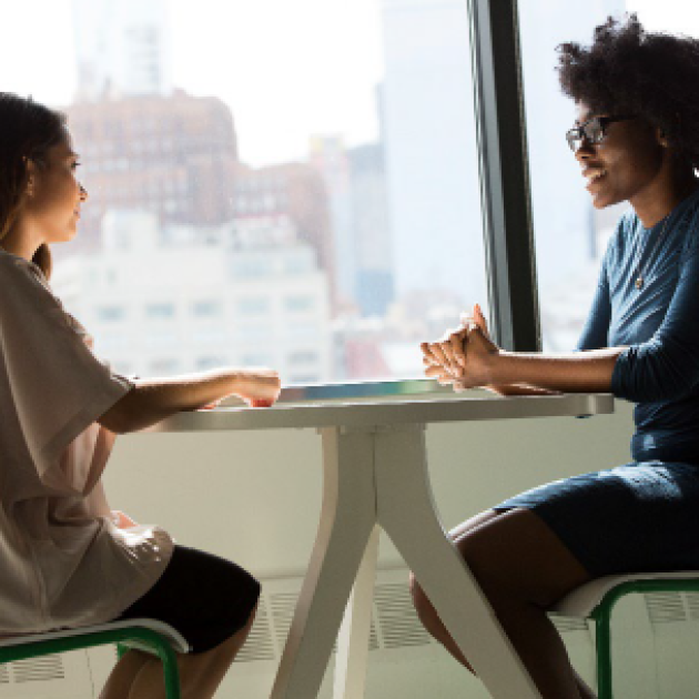 Enhancing Your Job Interview Skills Two people sitting around a table and talking