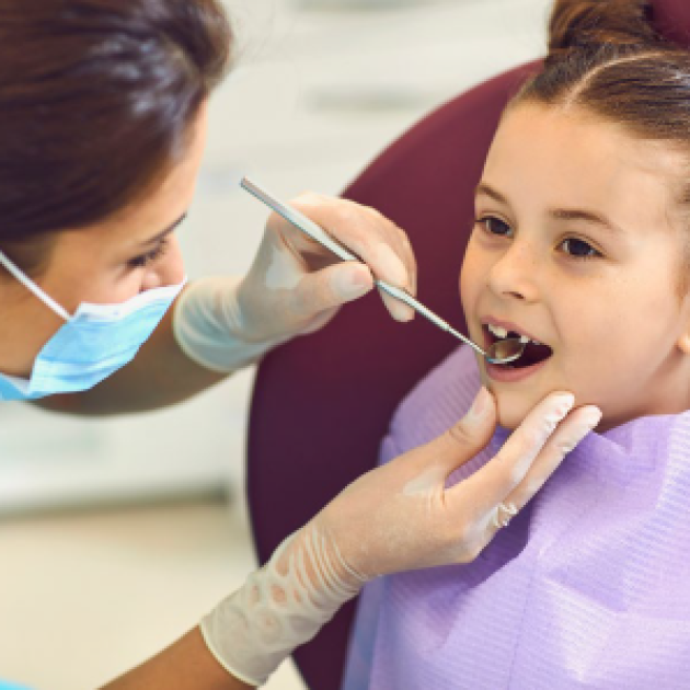Licensing for International Dentists and Hygienists A dentist examining a child's teeth