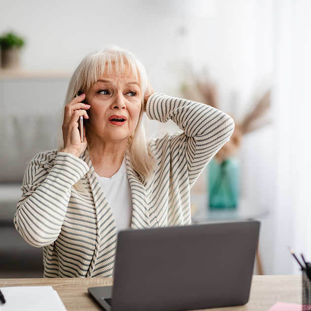a concerned-looking woman is talking on the phone