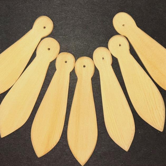 Paddles seven small regalia paddles displayed in a semicircle
