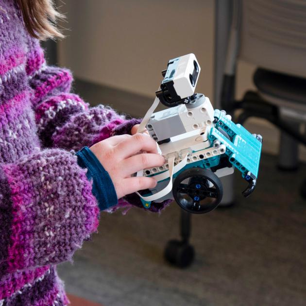 Lego robotics Child's hand holding Lego robot