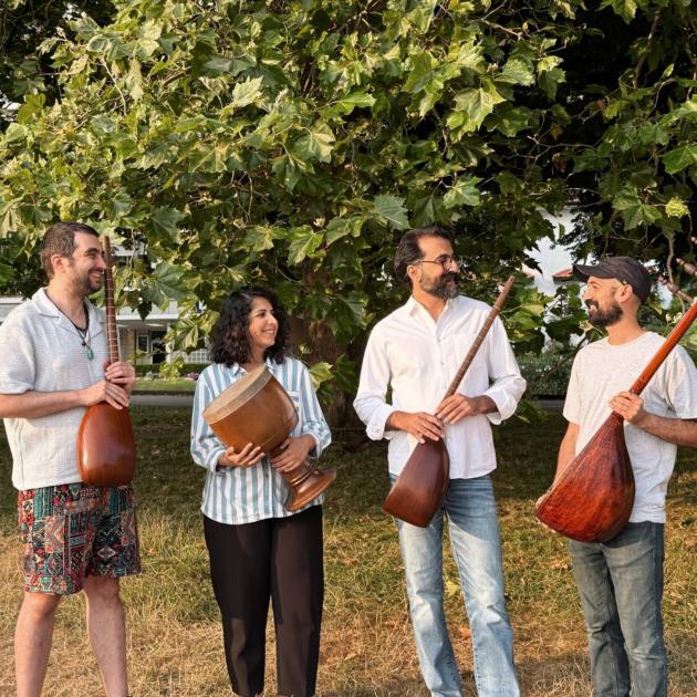 Three men holding string instruments and one woman holding a drum. 