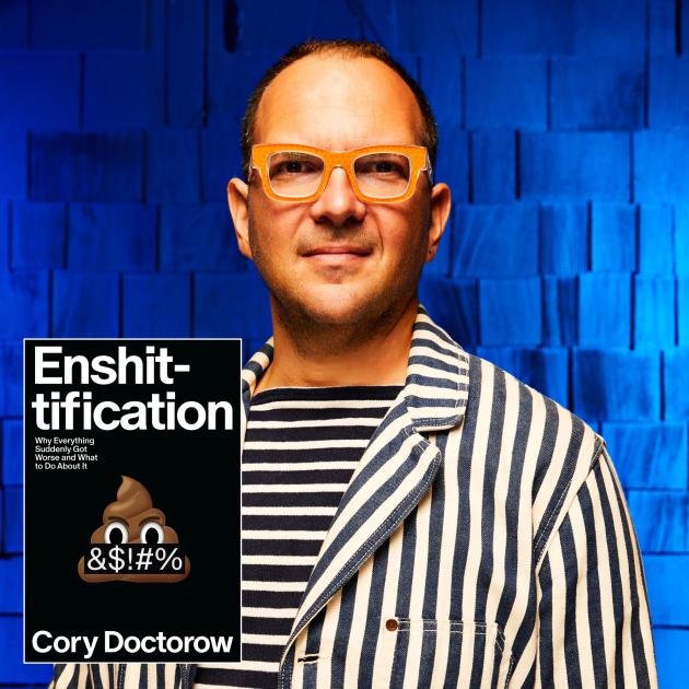Man wearing bold black and white striped clothes and thick-framed glasses, with book cover in foreground