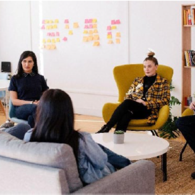 Five people sitting and talking
