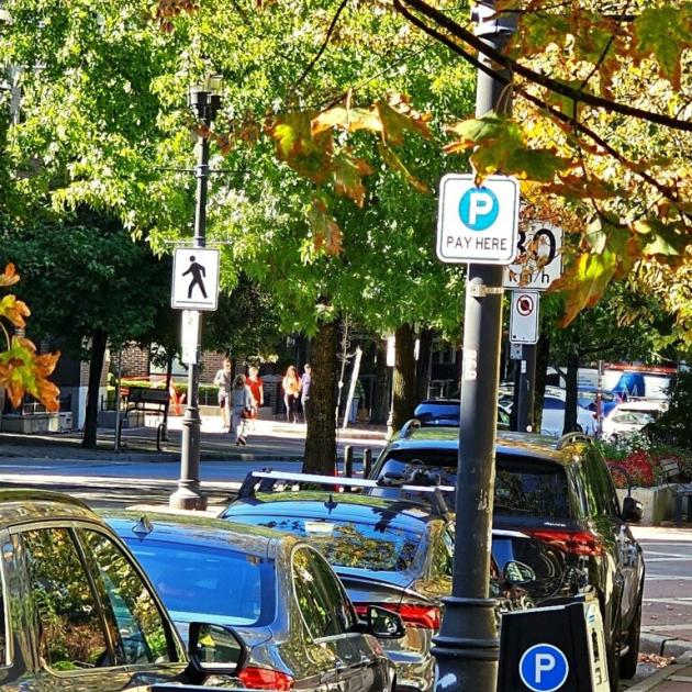 Cars parked under a Pay Here sign