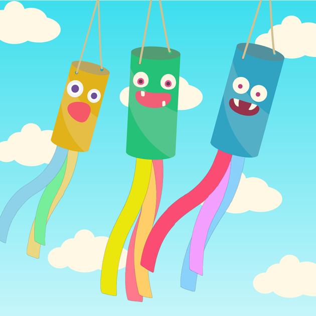 a yellow, green, and blue monster windsock with various colored streamers. White clouds with sky in the background