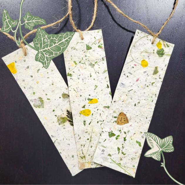 Three handmade bookmarks made of pressed leaves and flowers with ivy leaf design