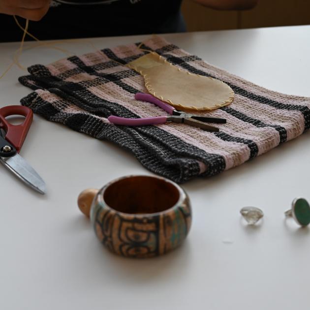 image of deer hide rattle being sewn