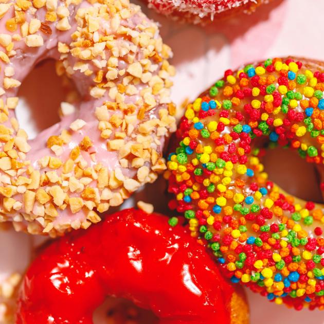 4 colourful doughtnuts are featured in a tight-framed image