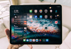 Hand holding an tablet showing home screen
