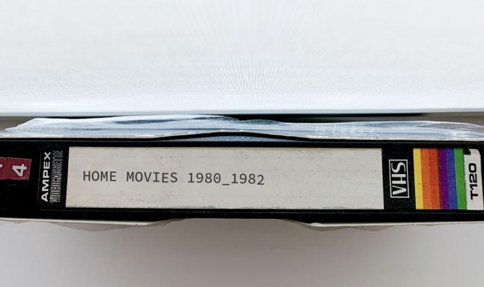 A photograph of a VHS tape with the label "Home Movies 1980_1982"