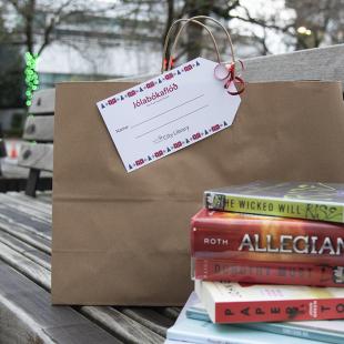 Bench outside the library, with a bag and books sitting on it