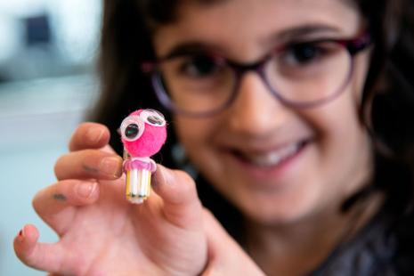 Picture of a girl holding a pink bristlebot