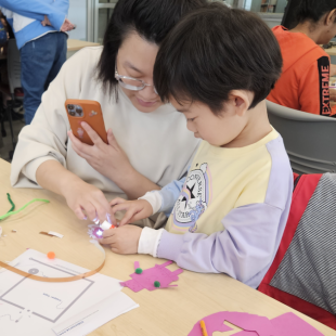 A mother and child doing a STEM project together