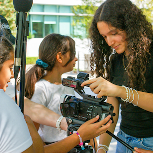 Teenagers operating a camera at a filmmaking camp