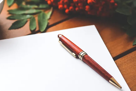 a pen lying on a piec of blank paper