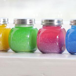Four mindfulness glitter jars in different colors: Yellow, green, pink, and blue. 