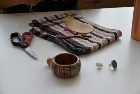 image of deer hide rattle being sewn