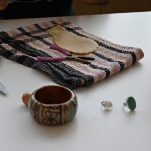 image of deer hide rattle being sewn